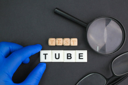 magnifying glass, glasses and hand holding the word test tube. research or science conceptの写真素材