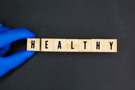 hand holding a wooden cube with the word healthy. healthy concept. health concept.の写真素材