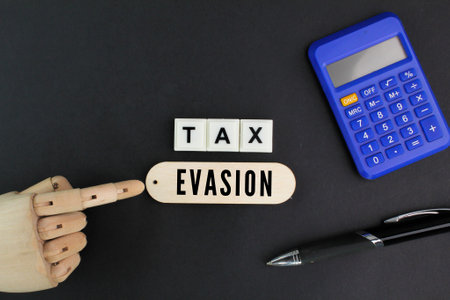calculator and pen with the word Tax Evasionの写真素材