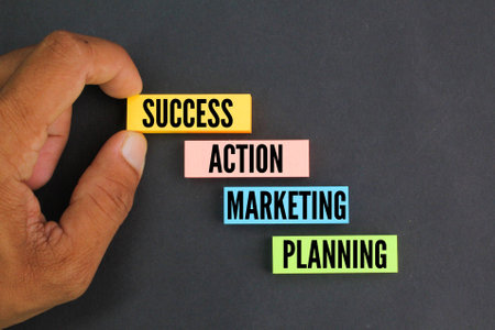 colored paper arranged in a ladder with the words Planning Marketing Action Success. concept for success. business marketing conceptの写真素材