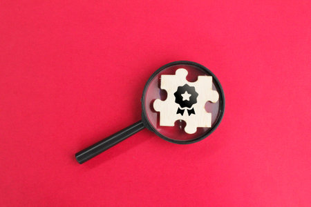 magnifying glass and puzzle with icons Quality Assurance, Assurance, Standards, ISO certification and standardization concept or looking for quality assuranceの写真素材
