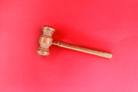 Judge's gavel on red background. concept of judgment or lawyerの写真素材