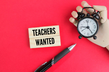 pen and bell with the words Teachers Wanted. the concept of looking for a teacher or instructorの写真素材