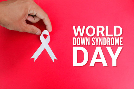 hand stretching the ribbon with the words World down syndrome day. World down syndrome day and learning difficulties awareness conceptの写真素材