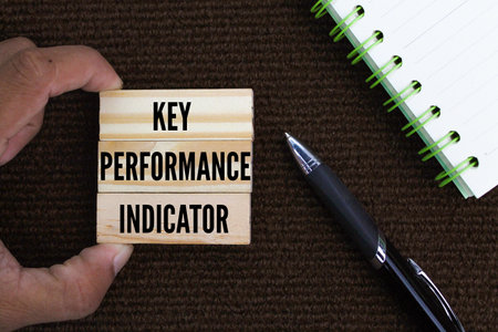 pen, book and stick with the words Key, Performance, Indicator or KPIの写真素材