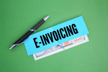 pen, paper and money with E-Invoicing. Business concept. Internet concept.の写真素材