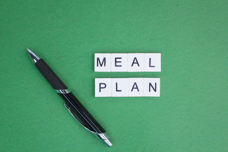 pen and alphabet letters with the word meal plan. the concept of a plan for a dietの写真素材