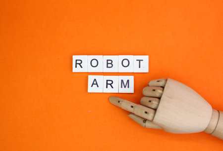 wooden hand and alphabet letters with the word robot arm. robot hand conceptの写真素材