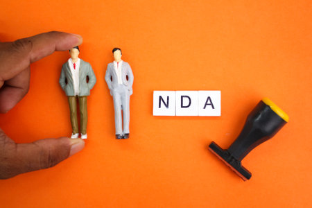 miniature people with the letters NDA or the word Non-Disclosure Agreement. the concept of consent. the concept of agreementの写真素材