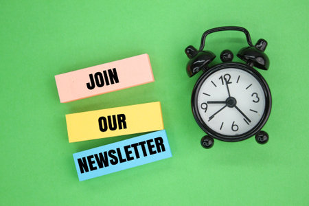 bell clock and colored paper with the words Join Our Newsletter. business marketing conceptの写真素材