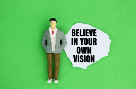 little people and paper with the words Believe in your own vision. the concept of self-motivation. the concept of self-improvementの写真素材