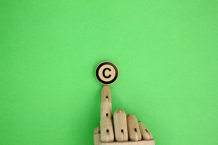wooden hand and letter C. copyright concept. the concept of intellectual property or intellectual propertyの写真素材