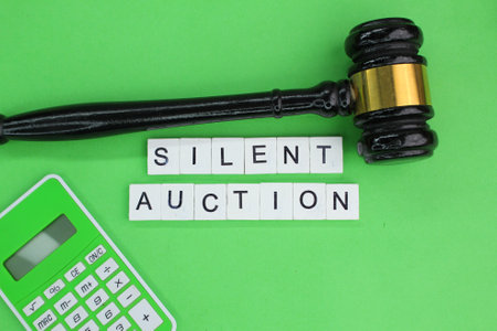 Judge hammer and calculator with the word silent auctionの写真素材