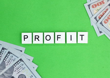 paper money and alphabetical letters with profit words. the concept of business profit or sales profitの写真素材