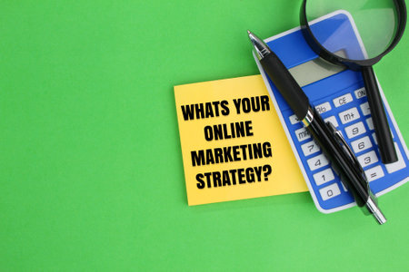 pen, calculator and magnifying glass with the question word Whats Your Online Marketing Strategy?の写真素材