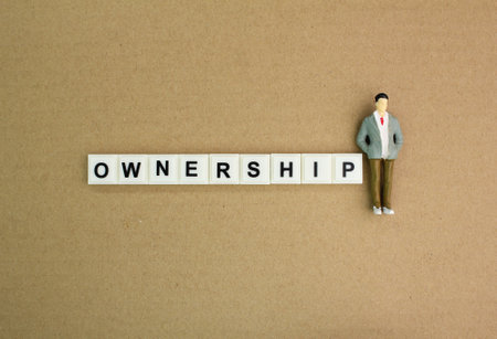 letter of the alphabet with the owner's word. concept of ownership. Ownership of a company or gardenの写真素材