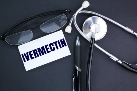 stethoscope, glasses and white paper with the word IVERMECTIN. medical and health conceptsの写真素材