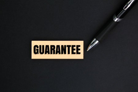 pen and paper with the word guarantee. warranty concept or warranty periodの写真素材