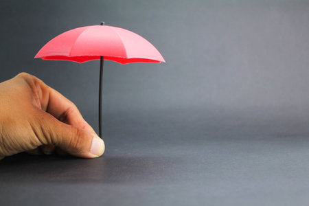 small red umbrella with a dark background. insurance coverage conceptの写真素材