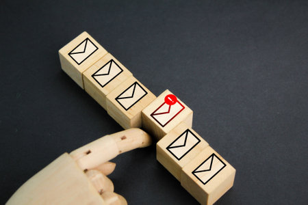 wooden cube with email and spam email icons. email scammers. Hack, steal password or personal data. Hacker, Virus, Worm, Trojan, Adware, Spyware, and Ransomware awareness.の写真素材