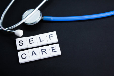 stethoscope and alphabet letters with the word self care. health care concept. health and beauty conceptの写真素材