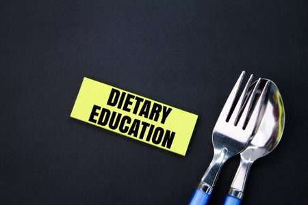 spoon, fork and paper colored with the word dietary education. the concept of dieting. the concept...