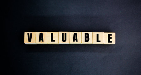 wooden cube with the word valuable. valuable concept or having good value. gold concept