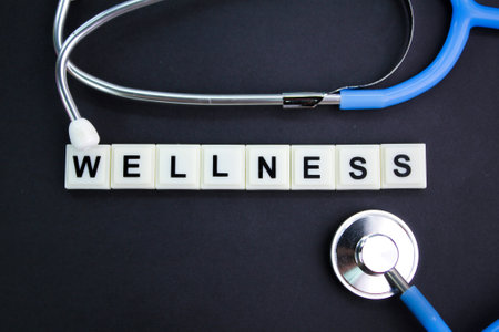 stethoscope and alphabet letters with the word wellness. health and medical conceptsの写真素材