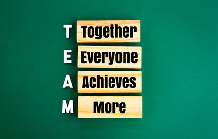 arrangement of wood with the word TEAM and the meaning of team. Together Everyone Achieves Moreの写真素材