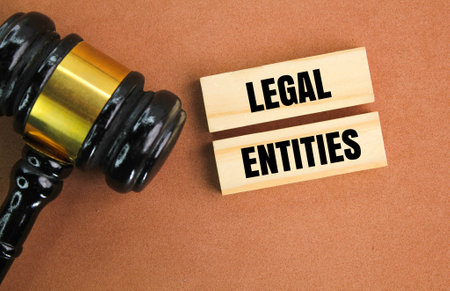 judge gavel and stick to the word legal entities. legal concept or valid lawの写真素材