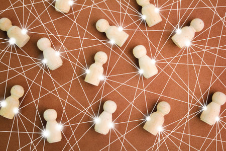 wooden figures connected by lines to each other. Cooperation and collaboration. Contact between...