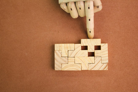 The wooden puzzle is arranged and completed. Concept of complex and smart logical thinking. Slightly...
