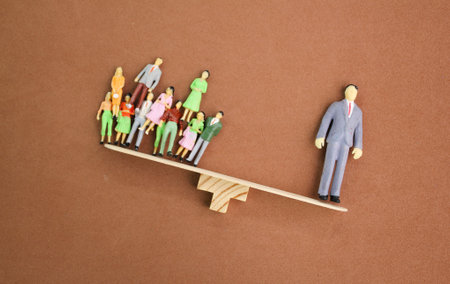the balance of miniature people workers and leaders. the leader is heavier. leaders are more valuable and good. High skill worker and talent concept.の写真素材
