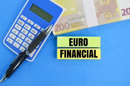 calculator, pen, euro coins and colored paper with the word Euro financial. the concept of investing...
