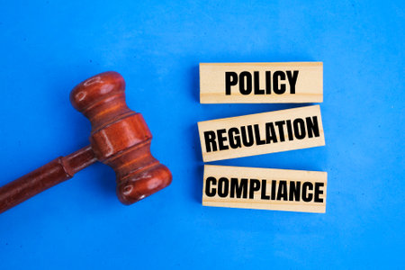 judge's hammer and stick to the words policy, regulation and compliance. industrial concept. the...