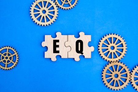 wooden puzzle and the letters EQ or the word emotional intelligence. emotions in positive ways to relieve stress, communicate effectively, empathize with others.の写真素材