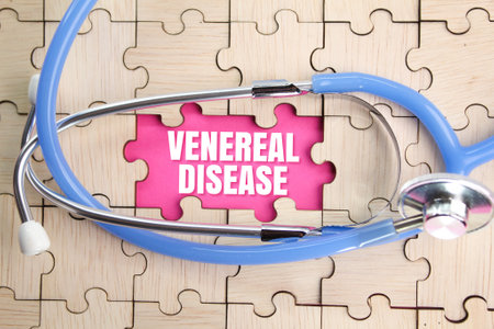 wooden puzzle and stethoscope with the word venereal disease. disease concept while having sex. STD conceptの写真素材