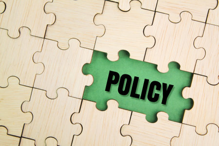 wooden puzzle with the word policy. basic concepts or organizational policies. a course or principle of action adopted. term conceptの写真素材
