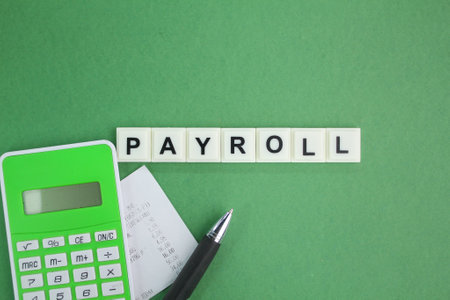 receipt, calculator, pen and letters of the alphabet with the word payroll. salary concept. salary payment conceptの写真素材