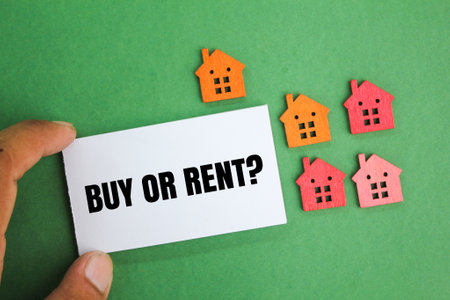 the shape of a small house with the words BUY OR RENT. the concept of real estate or mortgage. the concept of buying and selling a houseの写真素材