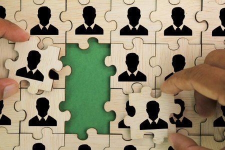 wooden puzzle with worker arrangement icon. the concept of human resources or HR. social networking, assessment center concept, personal audit or CRM conceptの写真素材
