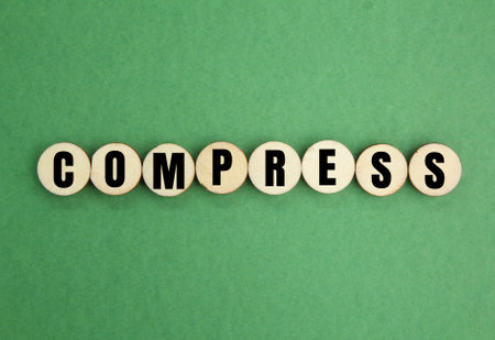 letters of the alphabet with the word compress. medical concept. flatten by pressure, squeeze or pressの写真素材