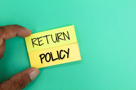 hand holding colored paper with the word RETURN POLICY. policy conceptの写真素材