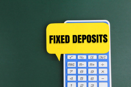 calculator and bubble paper conversation with the word FIXED DEPOSITS. business conceptの写真素材