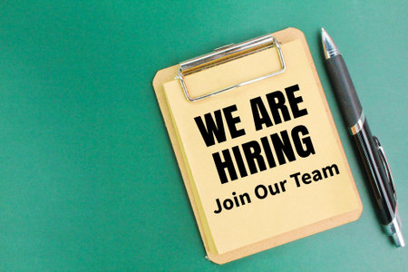 pen and paper board with the words We are hiring join our team. the concept of teamwork or human resources. HR conceptの写真素材