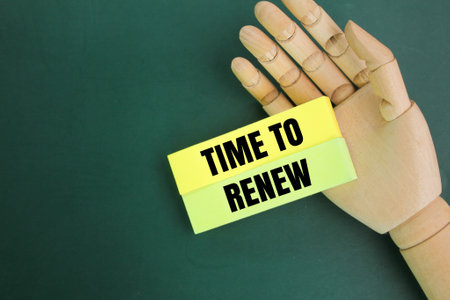 wooden hand and colored paper with the words Time to Renew. content concept or content review. contribution concept. conception periodの写真素材