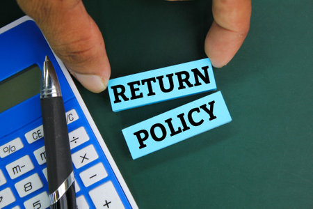 pen, calculator and colored paper with the word RETURN POLICY. business conceptの写真素材