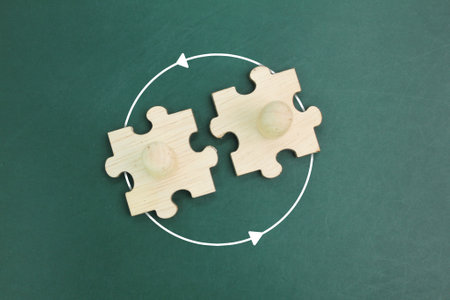 top view of a wooden puzzle with two pegdolls joined together. two wooden people join together....