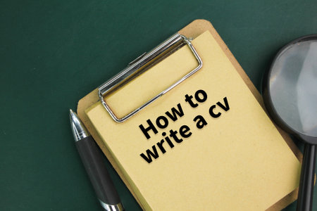 pen, magnifying glass and book board with the words How to write a cvの写真素材