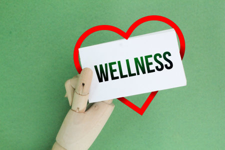 white paper and a love shape with the word WELLNESS. Wellness apple health concept